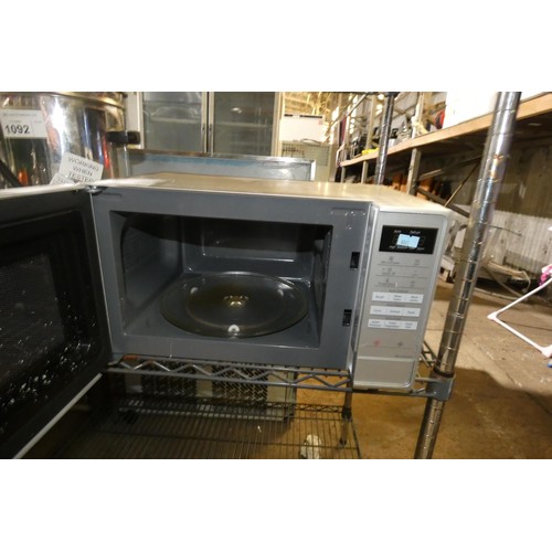 1093 - A microwave oven by Panasonic type NN-E28JMM - trade Tested Working