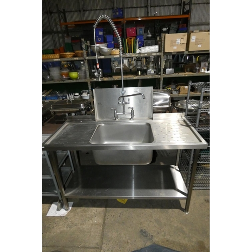 1124 - A commercial stainless steel single deep sink unit with draining board to the left and right, shelf ... 