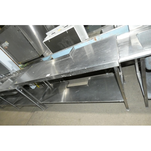 1137 - A commercial stainless steel catering type table with shelf beneath, the rear middle of table has a ... 