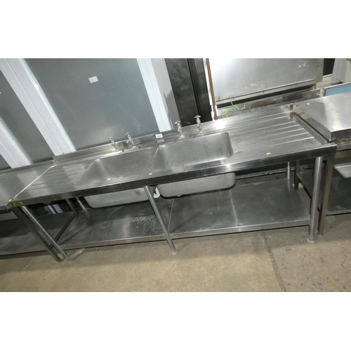 1138 - A commercial stainless steel double sink unit with shelf beneath approx 240x70cm by Bline