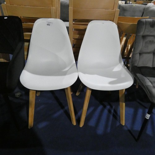 682 - 2 x white plastic dining chairs with wooden legs