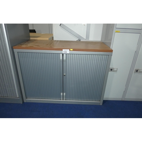 1326 - A silver metal tambour front storage cabinet with wood effect top approx 100 x 47 x 71cm high