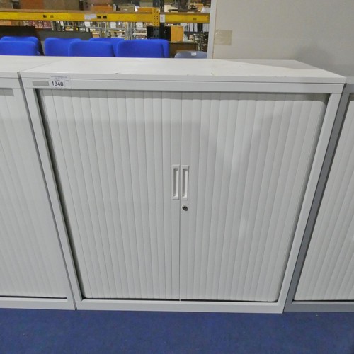 1348 - A white 2 door tambour cabinet by Triumph approx 100x48x110cm