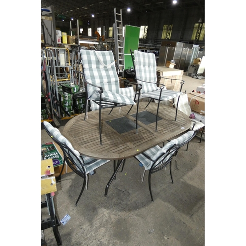 2066 - An oval wood / metal garden table approx 210 x 116cm and 6 x metal chairs with striped cushions