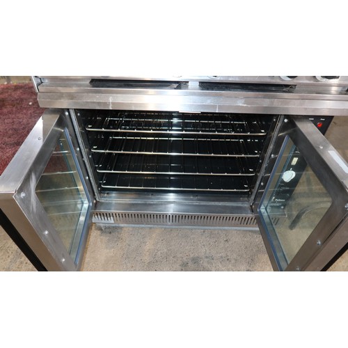 1182 - A commercial stainless steel gas fired 6 ring range with 2 door oven beneath model G102 - trade