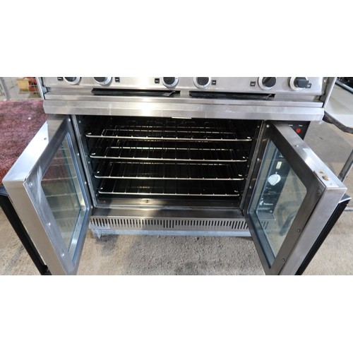 1182 - A commercial stainless steel gas fired 6 ring range with 2 door oven beneath model G102 - trade