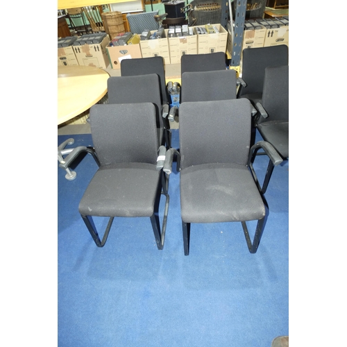 1260 - A set of 6 metal framed cantilever chairs with black upholstered seats