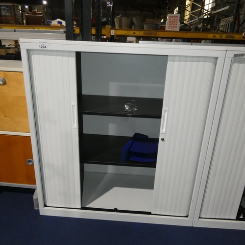 1294 - A white 2 door tambour cabinet by Triumph approx 100x48x110cm