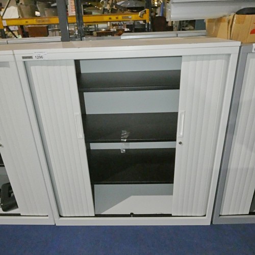 1296 - A white 2 door tambour cabinet by Triumph approx 100x48x110cm - damaged