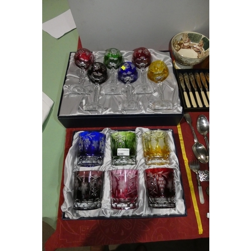 A boxed set of decorative colored cut glass goblets and a boxed set of colored cut glass tumblers
