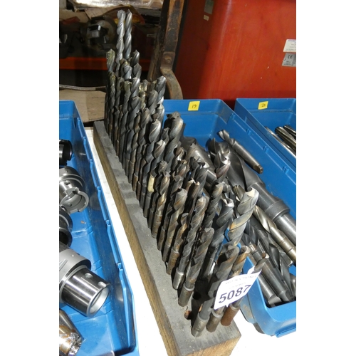 5087 - A wooden stand containing a quantity of various taper shank drill bits