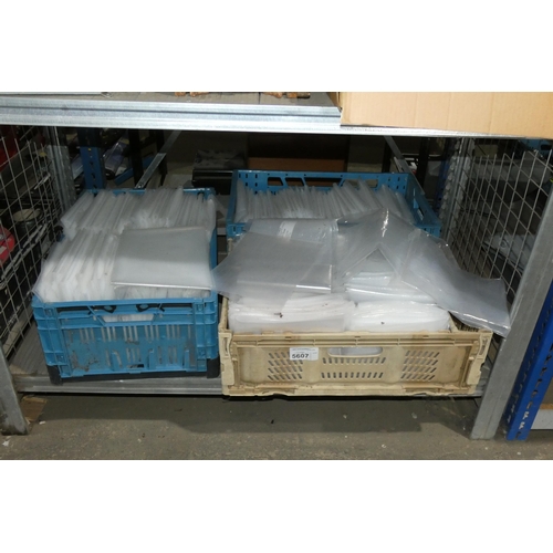 5607 - A quantity of various long / thin plastic bags. Please note that the two plastic crates are not incl... 