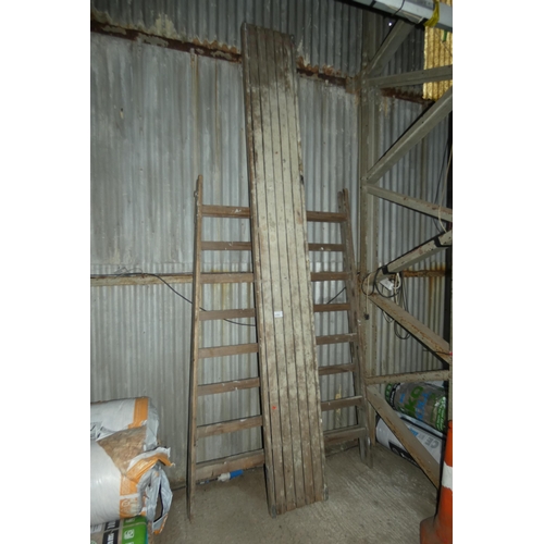 5757 - 2 x vintage folding wooden trestles type stands and 1 x vintage wooden board approx 3.6m long