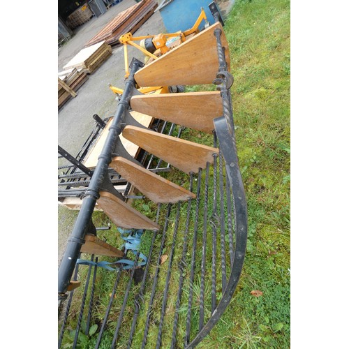 6005 - A metal framed spiral staircase with wooden steps measuring approximately 324 cm high x 140 cm wide ... 