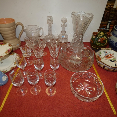 3195 - A large cut glass vase, two cut glass decanters, a cut glass jug, a large cut glass fruit bowl and o... 