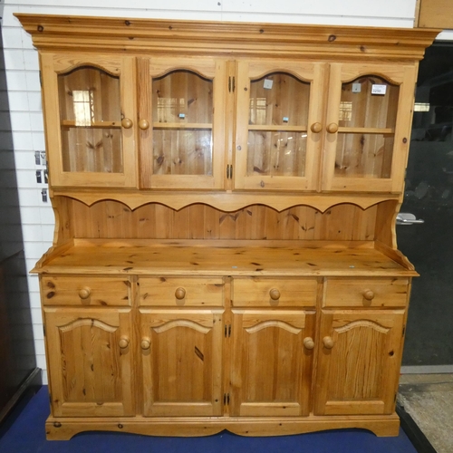 3250 - A pine kitchen dresser with four glazed doors above, four drawers and four panel doors below with tu... 