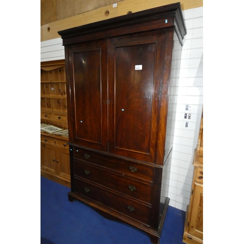 3252 - A dark mahogany linen press with two panelled doors enclosing hanging space and three drawers below,... 