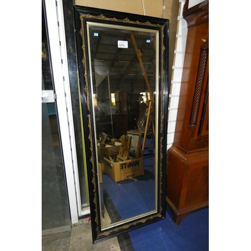 A large decorative black framed rectangular beveled wall mirror