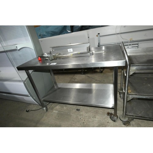 1299 - A mobile commercial stainless steel catering type table with shelf beneath approx 120x60cm