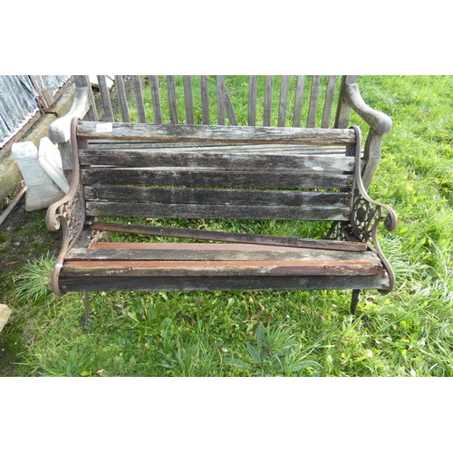 1350 - A wooden garden bench in need of repair, with metal ends