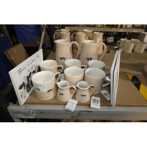 386 - A quantity of bovine related kitchenware, jugs mugs etc