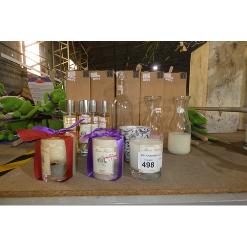 498 - A quantity of various fragrance diffusers and candles, contents of 1/2 a shelf