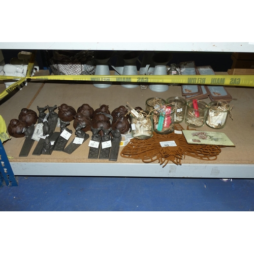 99 - A quantity of various items including novelty metal door wedges, metal door stops, metal labels etc