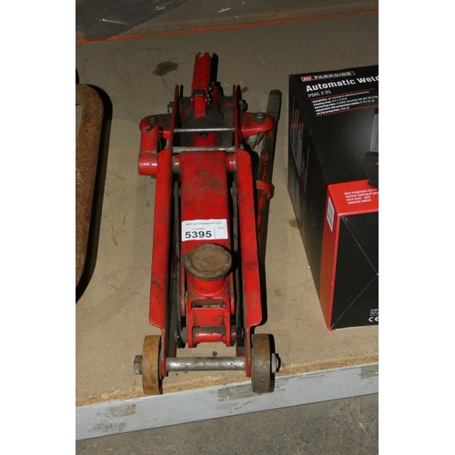 5395 - 1 x red metal trolley jack - No make or capacity visible