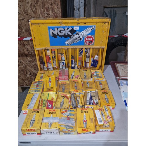 152 - A quantity of various spark plugs and a spark plug display unit by NGK