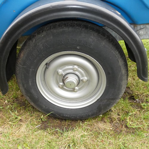 5997 - A blue plastic tow behind water bowser on a braked single axle trailer, capacity approx 1100L, has a... 