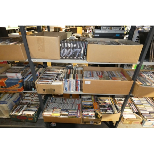 2447 - A large quantity of various DVDs and CDs, contents of 3 shelves