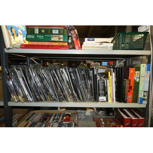 2448 - A quantity of various items including puzzles, books, Star Trek and Stargate magazines with DVDs, co... 