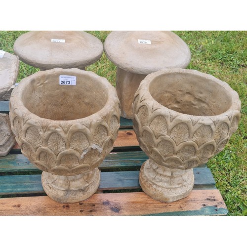 2673 - A pair of concrete pineapple style concrete planters