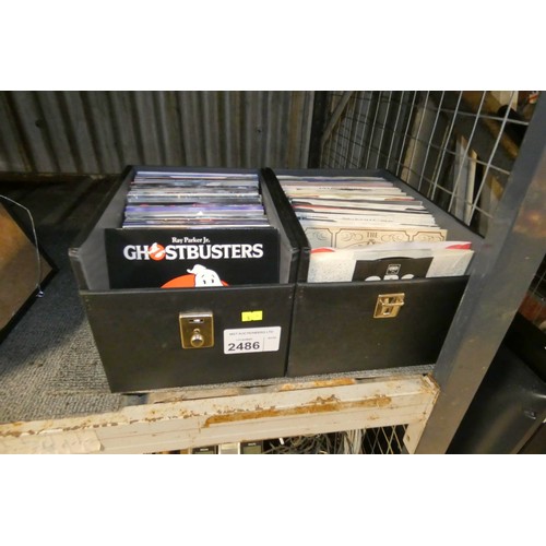 2486 - A quantity of various 45rpm vinyl singles in 2 carry cases, appear to be from the 80's