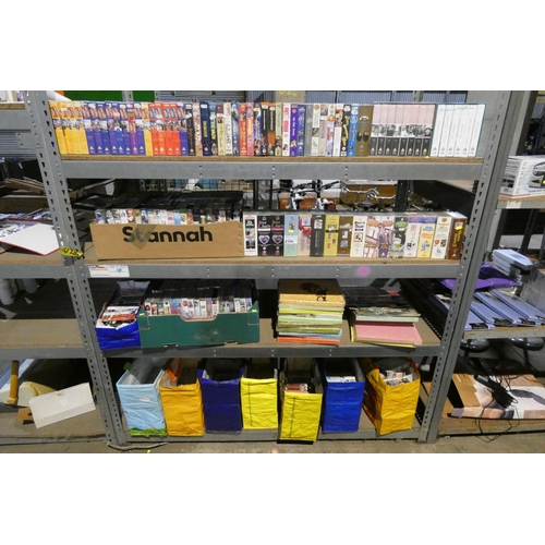 2104 - A quantity of various VHS video cassettes and vinyl records. Contents of 1 bay / 4 shelves and buyer... 