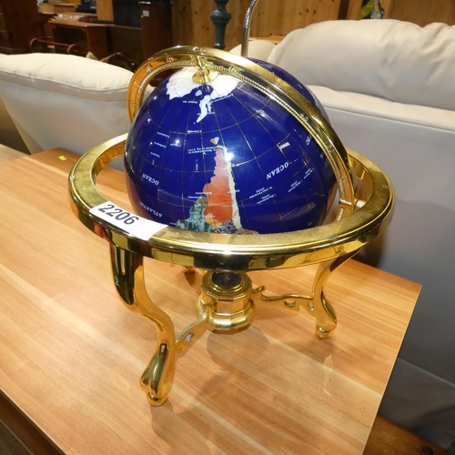 2206 - 1 x revolving polished inlaid stone globe in a gold coloured frame