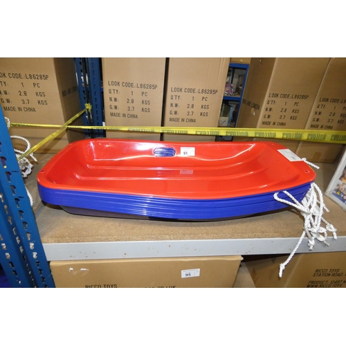 91 - 12 sledges by Kandytoys - 11 blue & 1 red