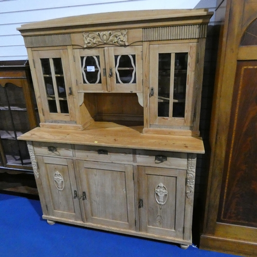 A vintage pine kitchen dresser with glazed doors above, three drawers