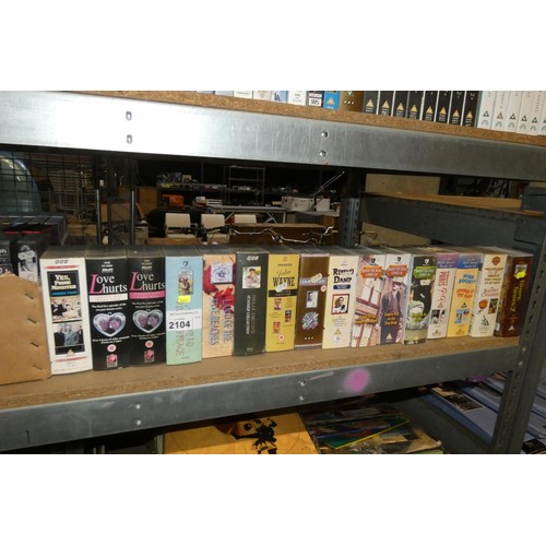 2104 - A quantity of various VHS video cassettes and vinyl records. Contents of 1 bay / 4 shelves and buyer... 