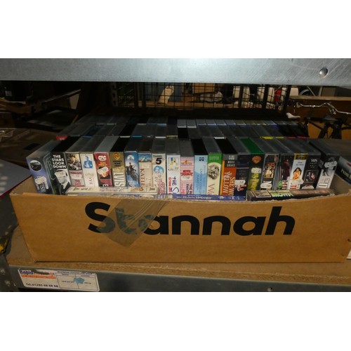 2104 - A quantity of various VHS video cassettes and vinyl records. Contents of 1 bay / 4 shelves and buyer... 