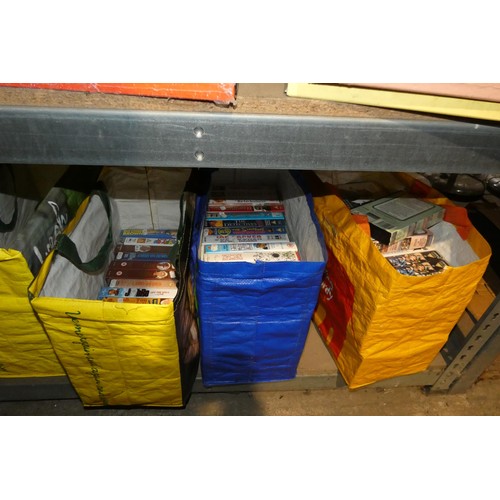 2104 - A quantity of various VHS video cassettes and vinyl records. Contents of 1 bay / 4 shelves and buyer... 