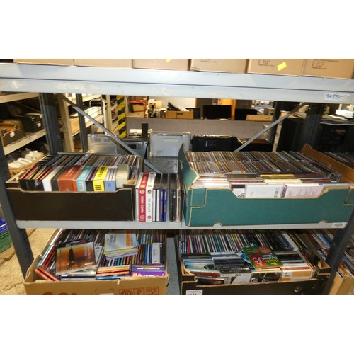 2445 - A large quantity of various DVDs and CDs, contents of 4 shelves