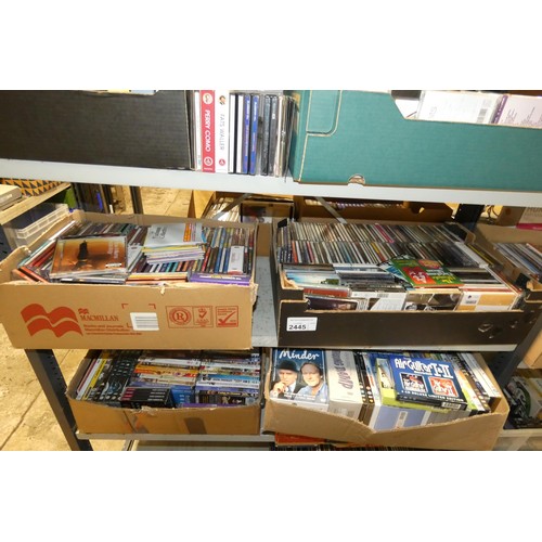 2445 - A large quantity of various DVDs and CDs, contents of 4 shelves