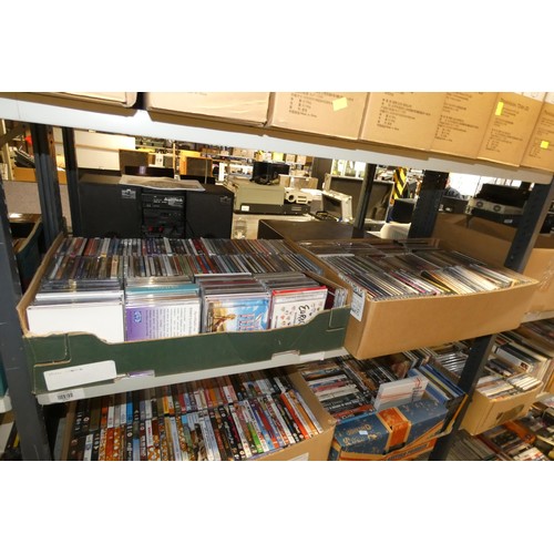 2446 - A large quantity of various DVDs and CDs, contents of 3 shelves