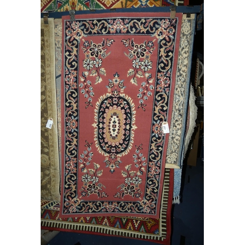 257 - A pink ground patterned rug approx 80*150cm