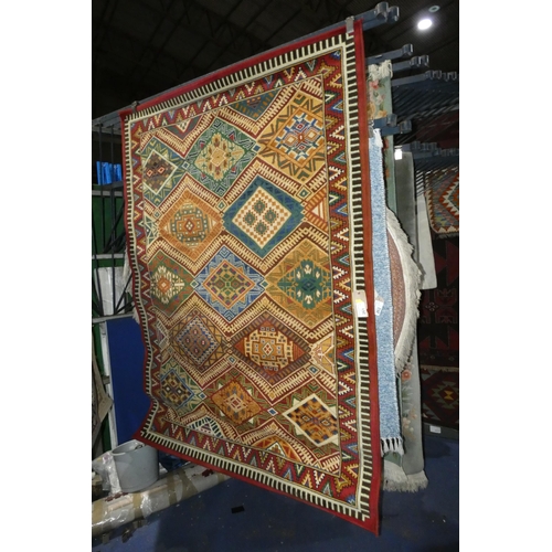 261 - A red ground Aztec style patterned rug approx 160*225cm