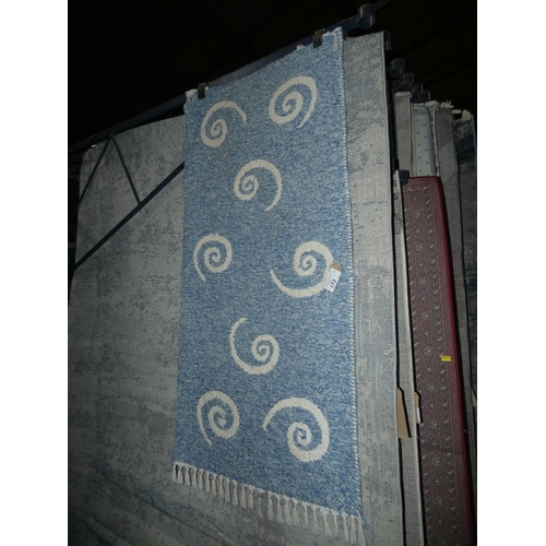 172 - A blue ground patterned rug approx 66 x 140cm