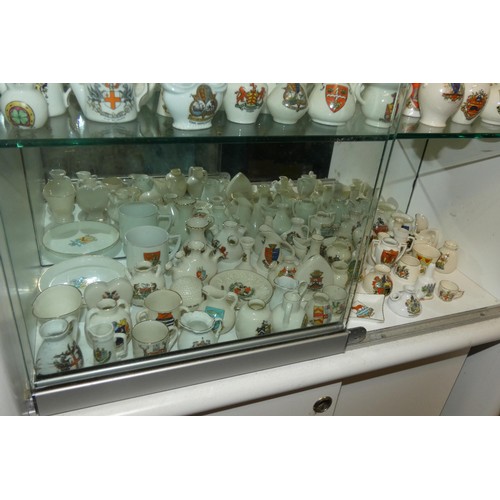 3096 - A large quantity of decorative miniature crested chinaware (5 shelves)