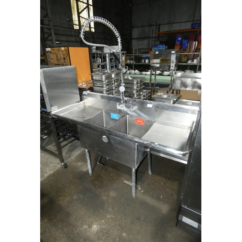 1192 - A commercial stainless steel double sink unit with draining boards both sides and spray tap, approx ... 