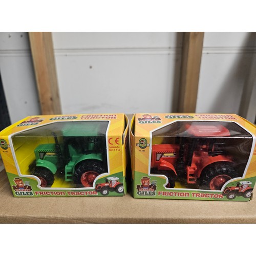 2859 - 2 x boxes of friction powered toy tractors by Farmer Giles